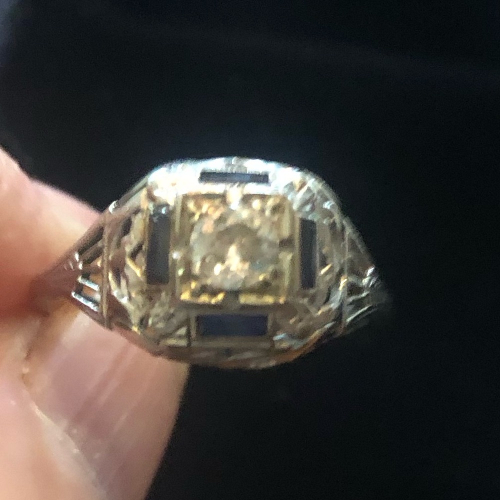 Elegant platinum ring with diamonds and sapphires.